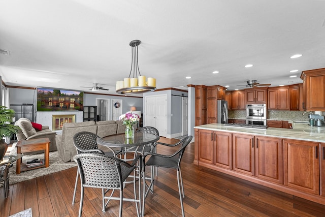 dining space featuring ceiling fan, dark wood finished floors, and recessed lighting
