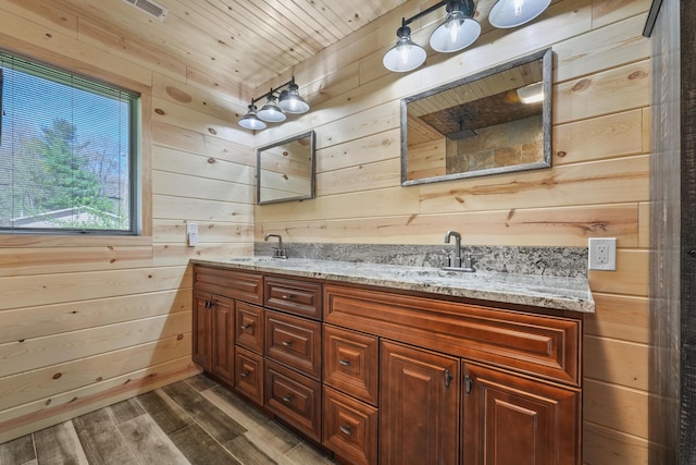 full bathroom with wood walls, wood finished floors, double vanity, wood ceiling, and a shower