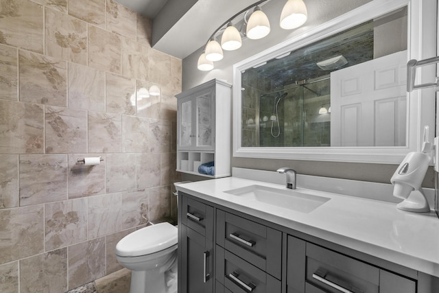 bathroom featuring a shower stall, vanity, and toilet