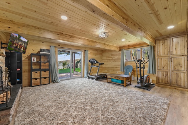 workout room with wood ceiling, wood finished floors, wood walls, and recessed lighting