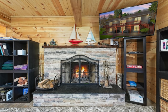 detailed view of wood ceiling, wooden walls, a fireplace, and wood finished floors