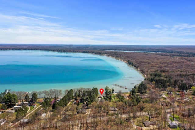 aerial view of a nearby body of water and a heavily wooded area