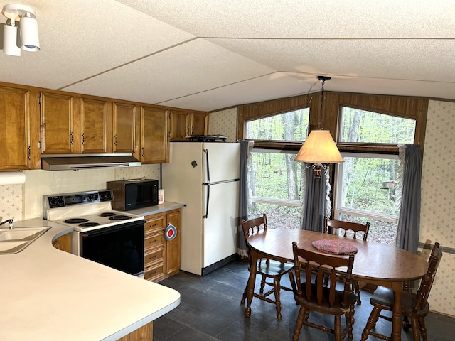 8448 Heatherton Cir, Mancelona, MI 49659 - kitchen featuring black microwave, freestanding refrigerator, range with electric cooktop, brown cabinets, and wallpapered walls