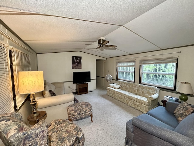 8448 Heatherton Cir, Mancelona, MI 49659 - living room with lofted ceiling, ceiling fan, carpet flooring, and a textured ceiling