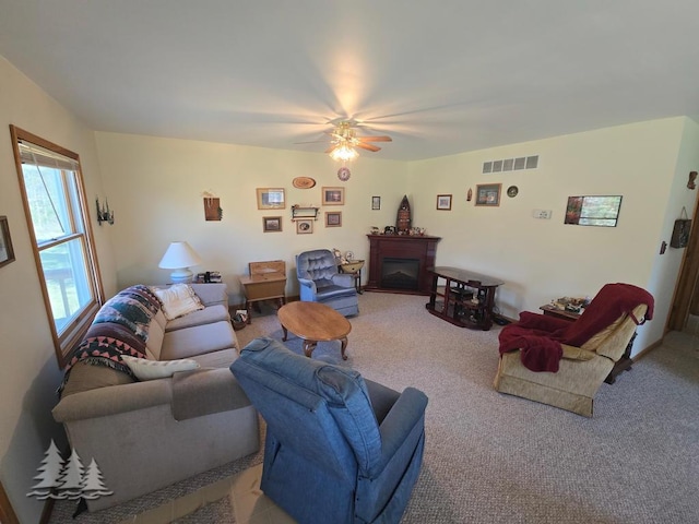 4795 Bruce Dr, Lewiston, MI 49756 - living room featuring carpet, ceiling fan, and a fireplace