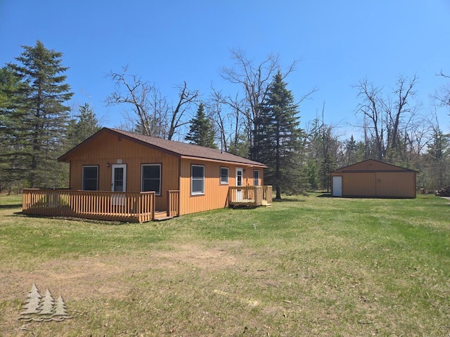 4795 Bruce Dr, Lewiston, MI 49756 - view of property exterior with a wooden deck, a yard, and an outdoor structure
