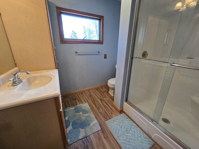 2623 W Dixon Lake Dr, Gaylord, MI 49735 - bathroom with wood finished floors, a stall shower, vanity, and baseboards
