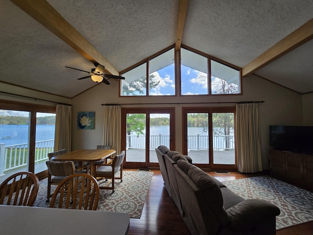 2623 W Dixon Lake Dr, Gaylord, MI 49735 - living area with a textured ceiling, a water view, ceiling fan, wood finished floors, and plenty of natural light