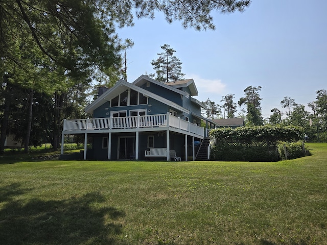 2623 W Dixon Lake Dr, Gaylord, MI 49735 - back of property with a wooden deck, stairs, a lawn, and a chimney