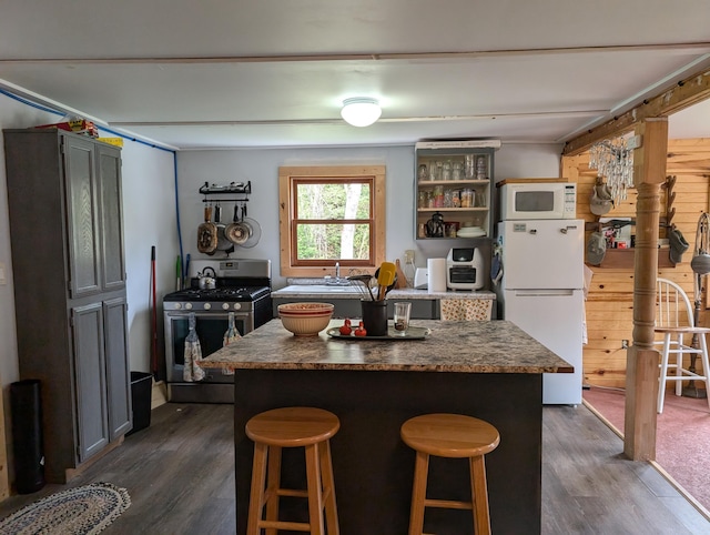 20563 S M32, Hillman, MI 49746 - kitchen featuring white appliances, dark wood finished floors, a kitchen island, and dark countertops