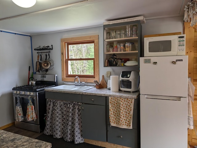 20563 S M32, Hillman, MI 49746 - kitchen featuring white appliances, wood finished floors, a sink, and open shelves