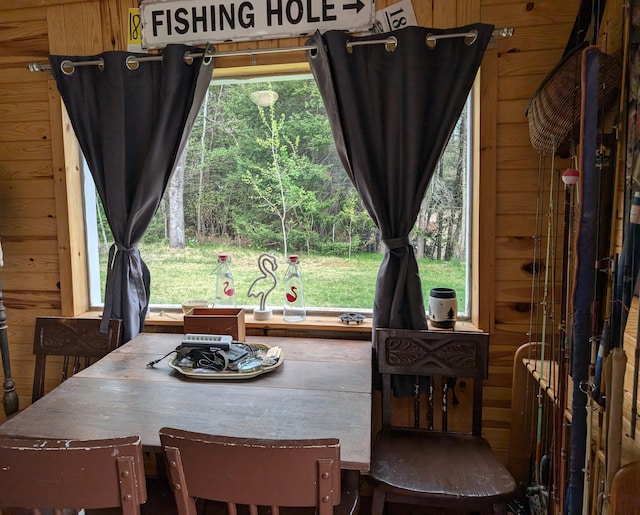 20563 S M32, Hillman, MI 49746 - dining room featuring wood walls and healthy amount of natural light