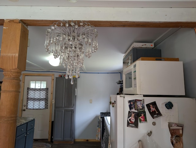 20563 S M32, Hillman, MI 49746 - kitchen with white appliances, a chandelier, and blue cabinetry