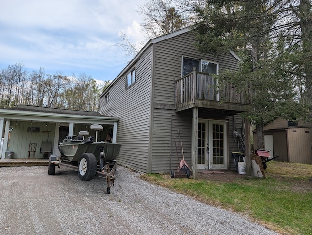 20563 S M32, Hillman, MI 49746 - view of home's exterior featuring a balcony and french doors