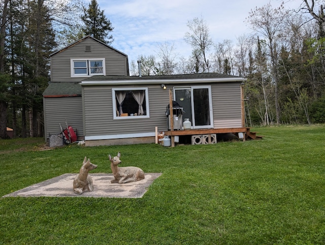 20563 S M32, Hillman, MI 49746 - rear view of house with a lawn and roof with shingles