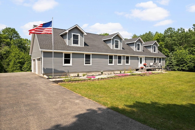 11758 Woodview Trl, Gaylord, MI 49735 - cape cod house with driveway, a front lawn, and roof with shingles