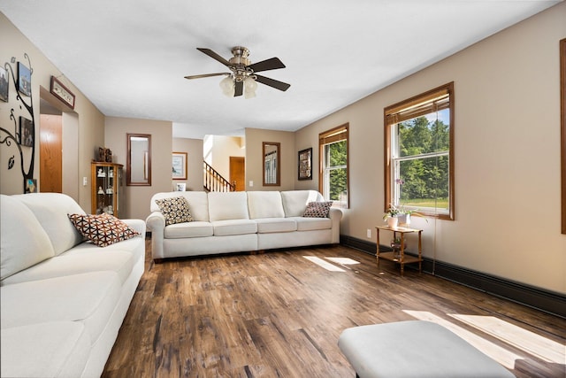 11758 Woodview Trl, Gaylord, MI 49735 - living room featuring wood finished floors, a ceiling fan, baseboards, and stairway