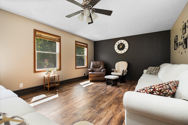 11758 Woodview Trl, Gaylord, MI 49735 - living area featuring wood finished floors, ceiling fan, and baseboards