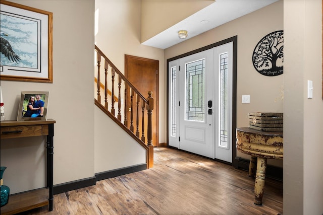11758 Woodview Trl, Gaylord, MI 49735 - foyer entrance with stairs, wood finished floors, and baseboards