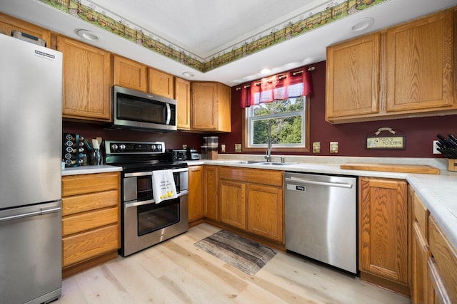 11758 Woodview Trl, Gaylord, MI 49735 - kitchen featuring stainless steel appliances, a sink, light wood-style flooring, and light countertops