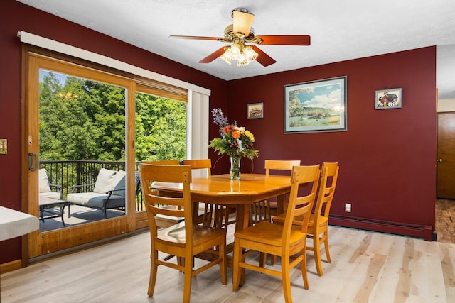 11758 Woodview Trl, Gaylord, MI 49735 - dining area with light wood finished floors, a ceiling fan, and a baseboard heating unit