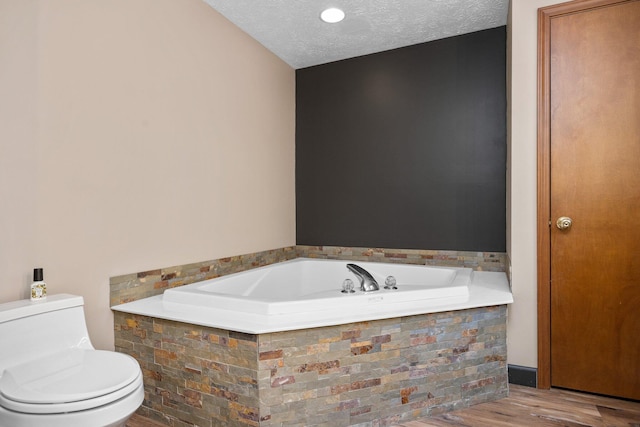 11758 Woodview Trl, Gaylord, MI 49735 - full bath featuring toilet, wood finished floors, a bath, and a textured ceiling
