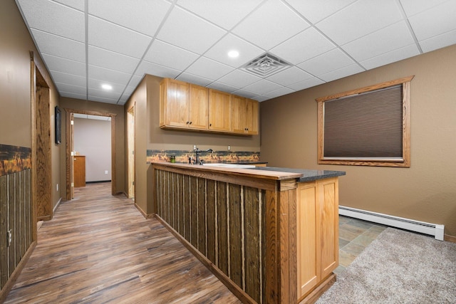 11758 Woodview Trl, Gaylord, MI 49735 - bar featuring baseboard heating, a paneled ceiling, baseboards, dark wood-style flooring, and recessed lighting