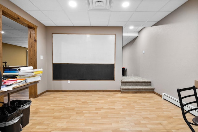 11758 Woodview Trl, Gaylord, MI 49735 - cinema room featuring a baseboard heating unit, baseboards, wood finished floors, a drop ceiling, and recessed lighting