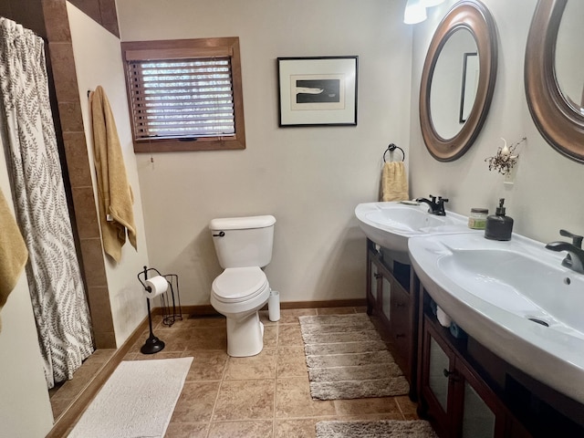 6475 W Legner Trl, Grayling, MI 49738 - full bathroom with toilet, tile patterned flooring, a shower with curtain, vanity, and baseboards