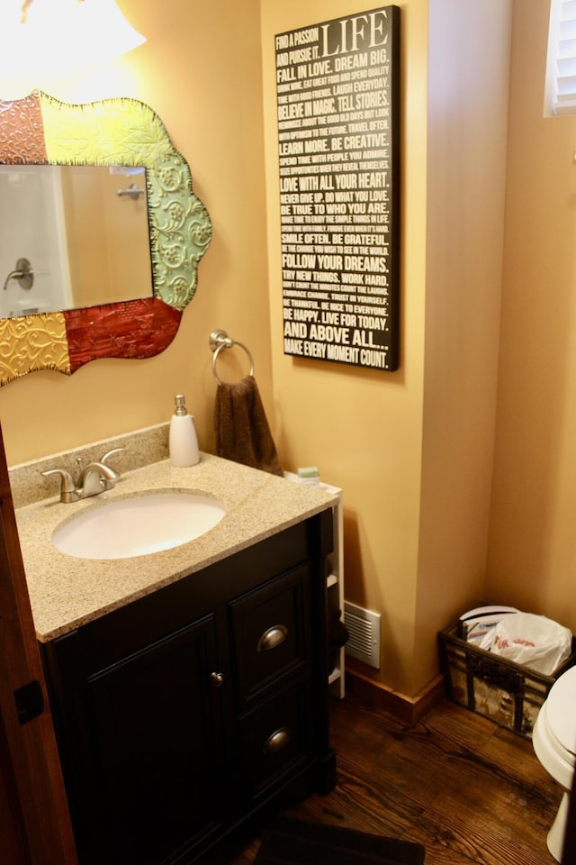 6475 W Legner Trl, Grayling, MI 49738 - half bath featuring vanity, wood finished floors, and toilet