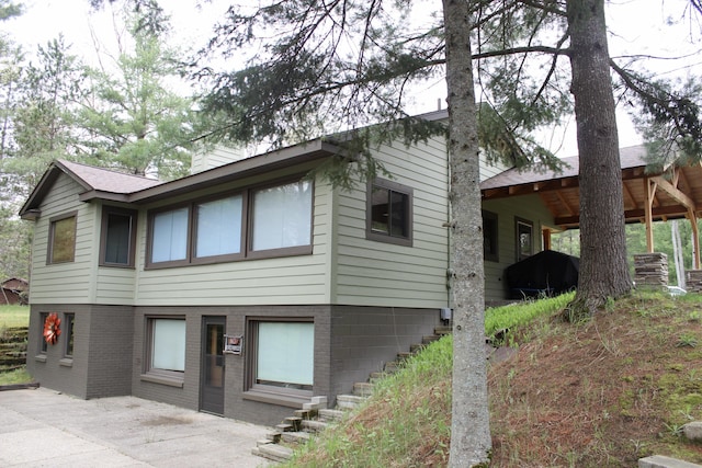 6475 W Legner Trl, Grayling, MI 49738 - view of front of home featuring a patio and brick siding