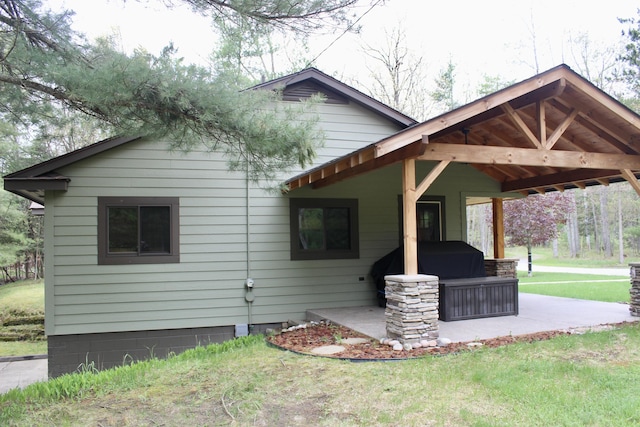 6475 W Legner Trl, Grayling, MI 49738 - view of home's exterior featuring a yard and a patio area