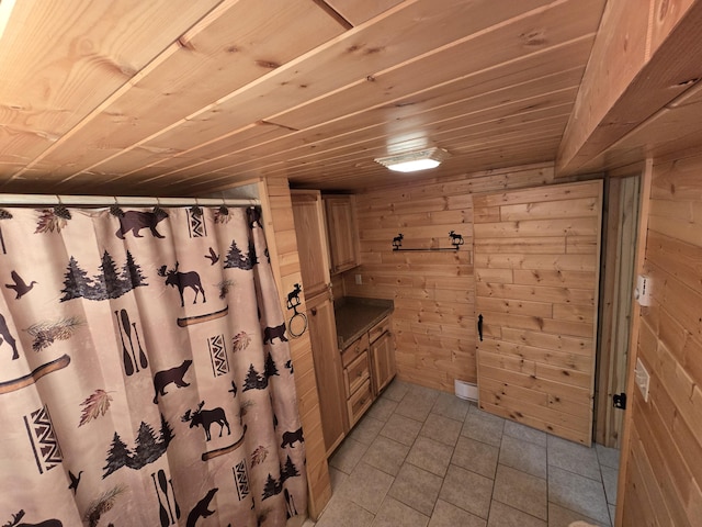 7912 Millecoquin Trl, Gaylord, MI 49735 - full bathroom featuring wooden walls, vanity, tile patterned floors, wooden ceiling, and curtained shower