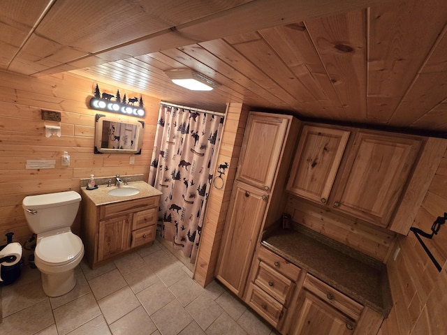 7912 Millecoquin Trl, Gaylord, MI 49735 - bathroom with wood walls, toilet, tile patterned flooring, wood ceiling, and vanity