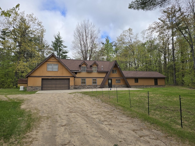 7912 Millecoquin Trl, Gaylord, MI 49735 - view of front of property with driveway, stone siding, and a garage