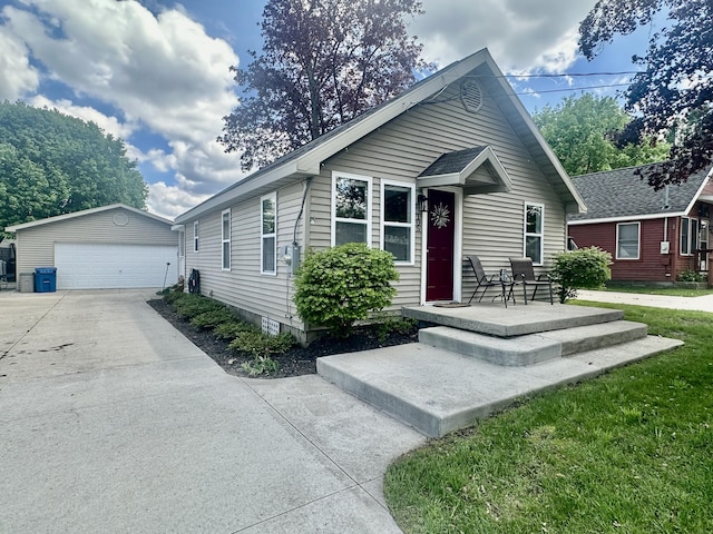 view of front facade featuring a detached garage and an outdoor structure
