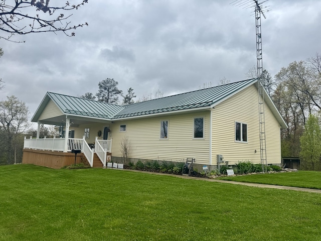870 Dalton Dr, Rose City, MI 48654 - back of house featuring a standing seam roof, a lawn, covered porch, stairway, and metal roof