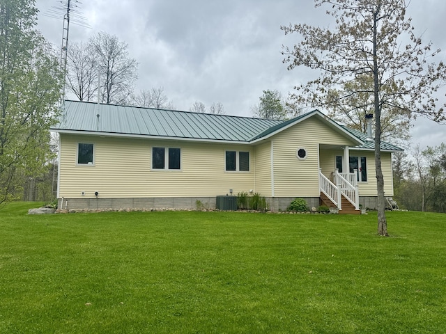 870 Dalton Dr, Rose City, MI 48654 - view of front of home with a front lawn, metal roof, a porch, and central air condition unit