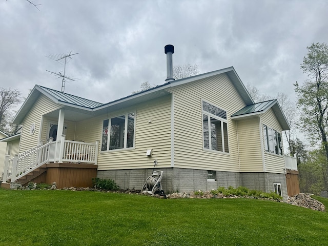 870 Dalton Dr, Rose City, MI 48654 - view of side of home with a yard, metal roof, and a standing seam roof
