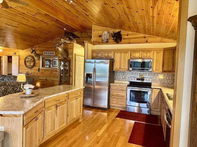 870 Dalton Dr, Rose City, MI 48654 - kitchen featuring stainless steel appliances, lofted ceiling, wooden ceiling, wooden walls, and light countertops