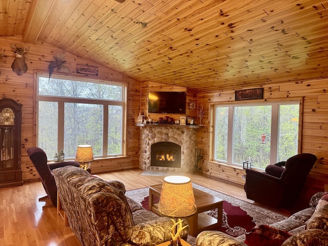 870 Dalton Dr, Rose City, MI 48654 - living room featuring wood walls, plenty of natural light, wood ceiling, light wood finished floors, and a fireplace