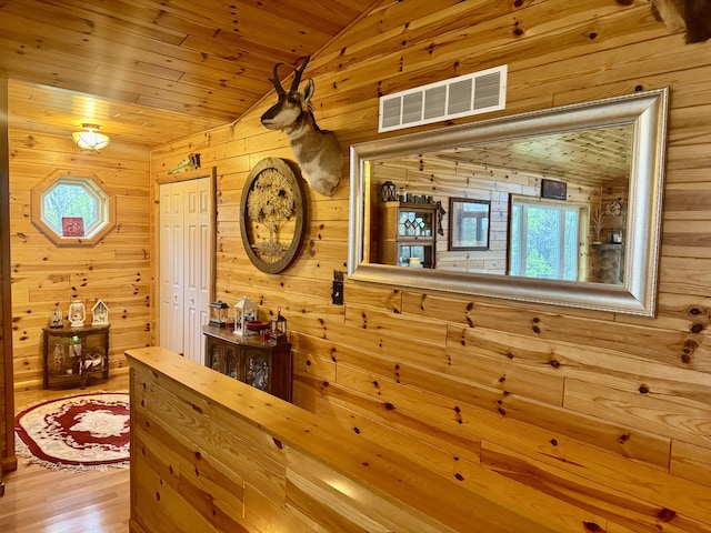 870 Dalton Dr, Rose City, MI 48654 - hall with wooden walls, lofted ceiling, wood ceiling, and wood finished floors