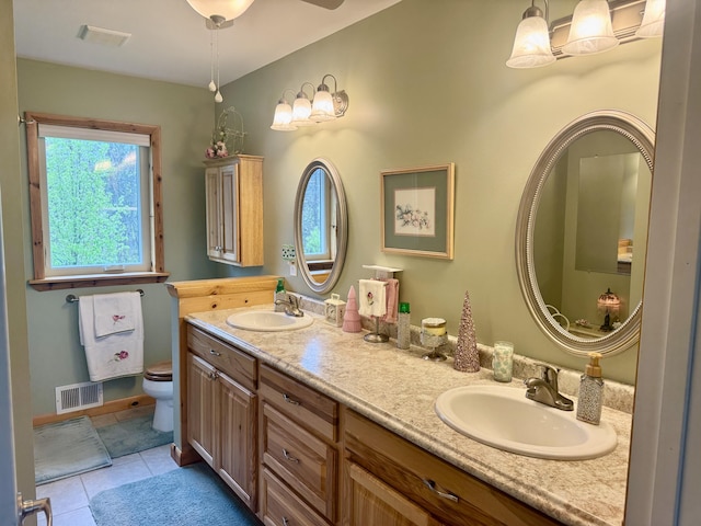 870 Dalton Dr, Rose City, MI 48654 - bathroom with toilet, double vanity, plenty of natural light, and tile patterned floors