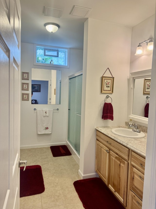 870 Dalton Dr, Rose City, MI 48654 - full bathroom featuring vanity, a stall shower, baseboards, and tile patterned floors