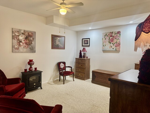 870 Dalton Dr, Rose City, MI 48654 - living area featuring carpet floors, a ceiling fan, baseboards, recessed lighting, and a wood stove