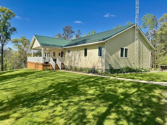870 Dalton Dr, Rose City, MI 48654 - back of house featuring a ceiling fan, a yard, stairway, and a metal roof