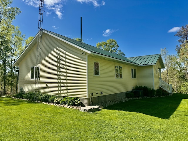 870 Dalton Dr, Rose City, MI 48654 - view of side of home with a yard and a metal roof