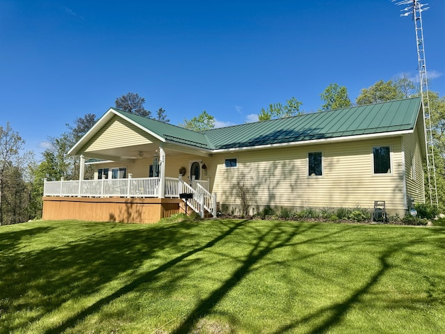 870 Dalton Dr, Rose City, MI 48654 - rear view of property with a yard, a standing seam roof, ceiling fan, and a metal roof
