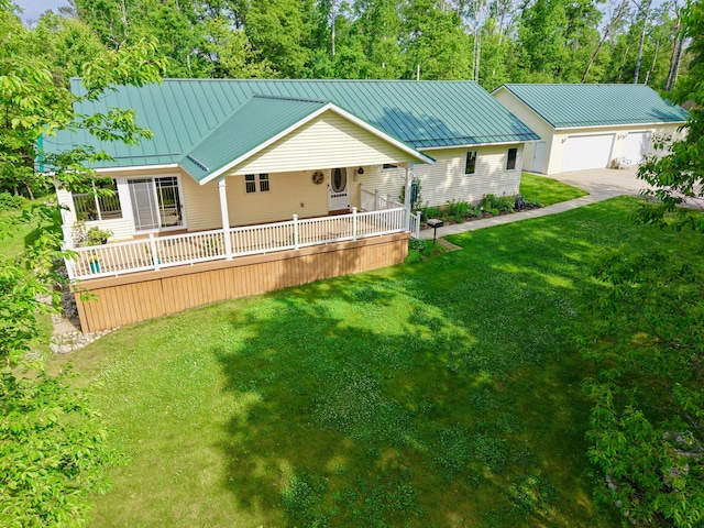 870 Dalton Dr, Rose City, MI 48654 - view of front of house featuring a standing seam roof, a front lawn, a detached garage, and a metal roof