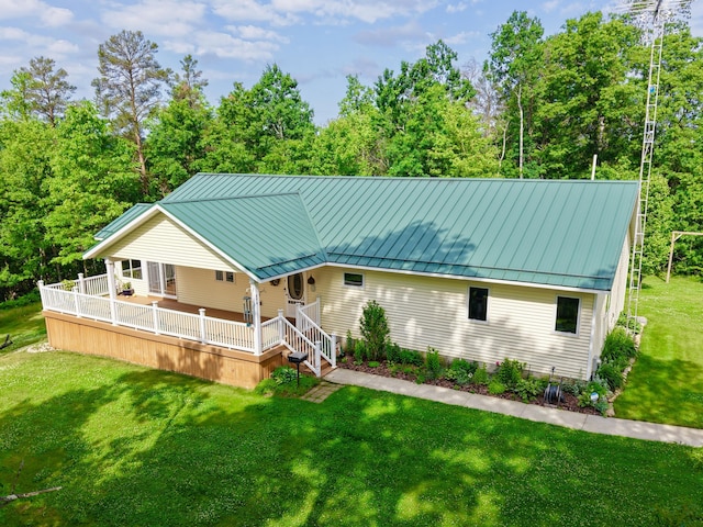 870 Dalton Dr, Rose City, MI 48654 - view of front facade featuring a standing seam roof, a front lawn, and a metal roof